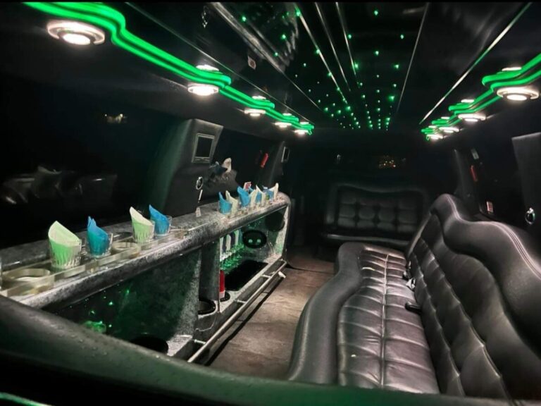 Interior of limousine with green lights and white and blue glasses